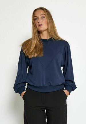 Sweatshirt bleu marine à manches longues, présentant un design en forme de V à l'avant et des poignets froncés. Fabriqué en matériau doux, coupe décontractée.