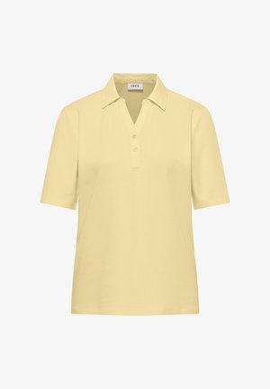 Kortærmet beige poloshirt med krave, to knapper og V-udskæring, mærket "Cecil" inde i kraven.