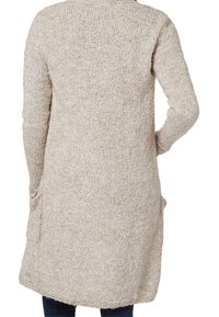 Long, knit cardigan in light beige with a textured pattern, featuring two side pockets and a straight hemline.