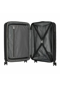 Black hard-shell suitcase with a gray interior, featuring a mesh zip pocket, elastic cross straps, and four wheels for easy mobility.