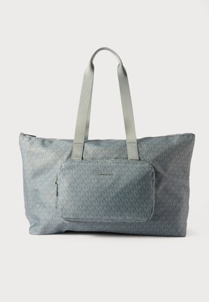 Tote bag in light blue fabric, featuring repeated geometric pattern, two straps, and a front zip pocket with logo hardware.