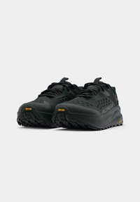 Czarne buty do biegania w terenie z oddychającą cholewką, teksturowaną powierzchnią, wzmocnionym czubkiem i podeszwą Vibram zapewniającą przyczepność.