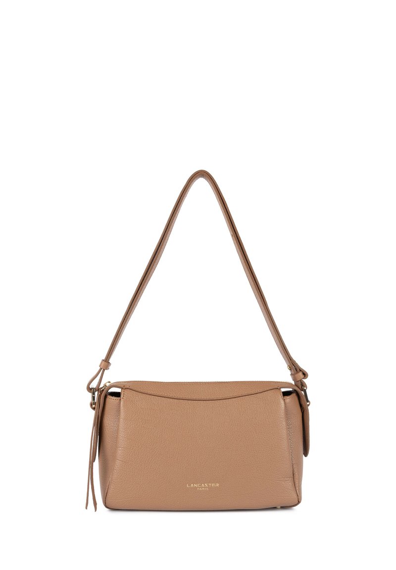 Tan leather shoulder bag with a structured design, rounded edges, top zipper closure, and a single adjustable strap. Gold logo detail on front.