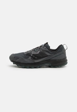 Dunkelgrauer und schwarzer Trailrunning-Schuh mit grober Sohle, Mesh-Obermaterial, Schnürsenkeln und Zuglasche an der Ferse, beschriftet mit Gore-Tex und Excursion TR 16.