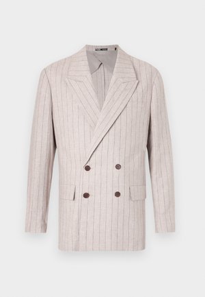 Double-breasted blazer in light beige linen with subtle pinstripes, featuring wide lapels and dark brown buttons. Two front pockets included.