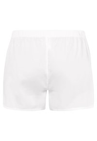 Shorts blancs avec une coupe décontractée, dotés d'une taille élastique. Fabriqués en tissu lisse avec un design simple et uni.