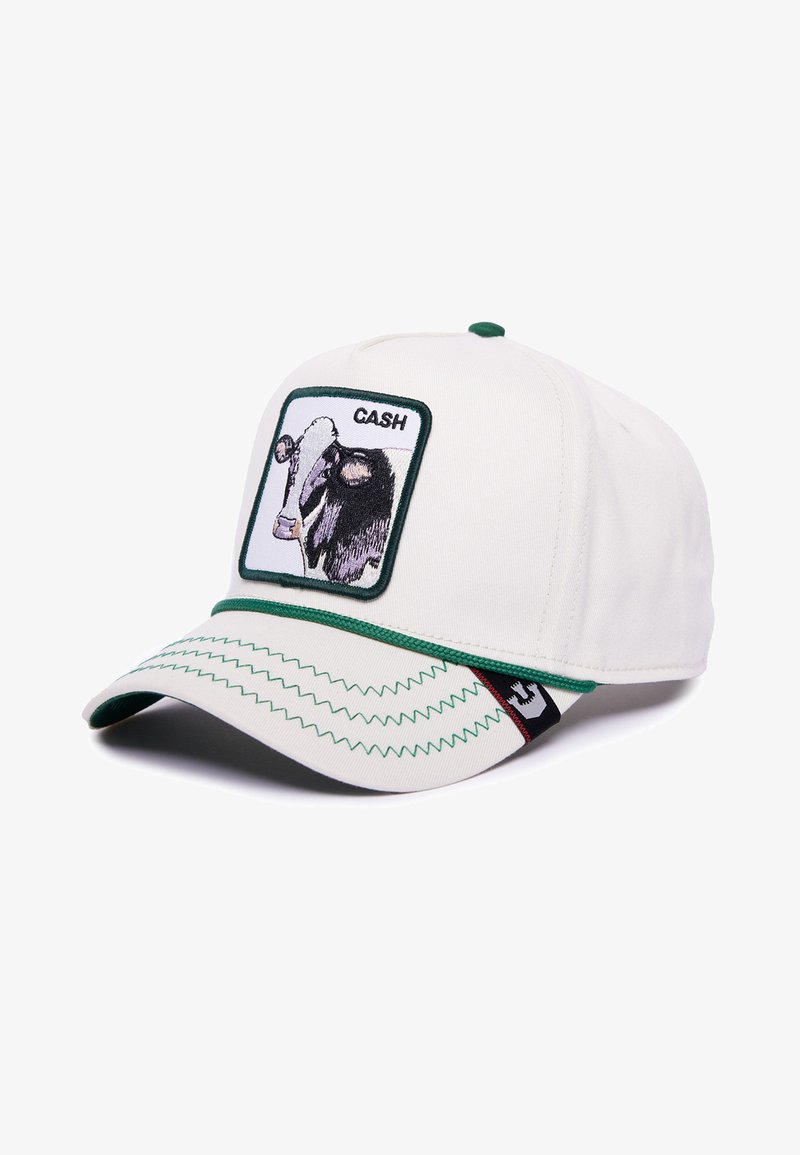 White cap with green accents, featuring a cow graphic patch labeled "CASH" and zigzag stitching on the visor. Cotton material.