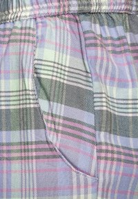 Plaid fabric in light blue, green, pink, and gray with vertical and horizontal stripes; features a pocket on the side. Texture appears smooth.