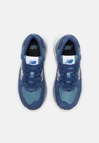 Marina sneakers med övre i mesh och mocka, blå accenter, rund tå, platta snören och vitt logodetalj på tungan och sidan. Mönstrad sula.