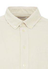 Light beige corduroy shirt with a classic collar, button front, single chest pocket, and textured fabric. Buttons are white and circular.