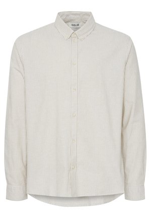 Valkoinen ja beige raitapaita, jossa on pitkät hihat ja terävä kaulus, pyöreä helma ja hienovarainen rakenne.