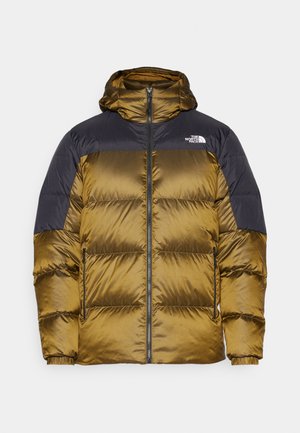 Giacca a vento imbottita in giallo scuro e blu marino, con cappuccio, zip frontale e due tasche laterali. Realizzata in tessuto liscio, leggero e isolante.