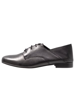 Black leather shoe with a smooth finish, pointed toe, lace-up design, and a low, stacked heel. Features a subtle texture on the upper.