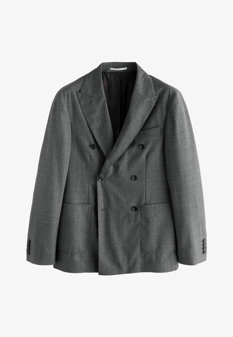 Kétrészes, szürke, texturált anyagból készült zakó nagy elülső zsebekkel, hegyes hajtókákkal és fekete gombokkal. Béléssel ellátva.