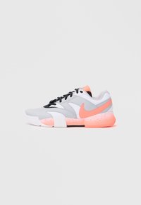 Grey athletic shoe with white and black accents. Features a pink swoosh logo and a textured, pink-speckled sole. Laces are black.