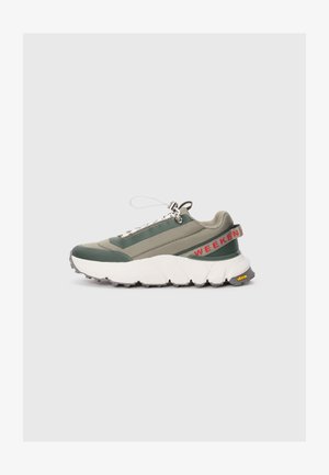 Green and gray sneaker with textured upper, white chunky sole, front lacing, and "WEEKEND" lettering on the back. Vibram logo on sole.