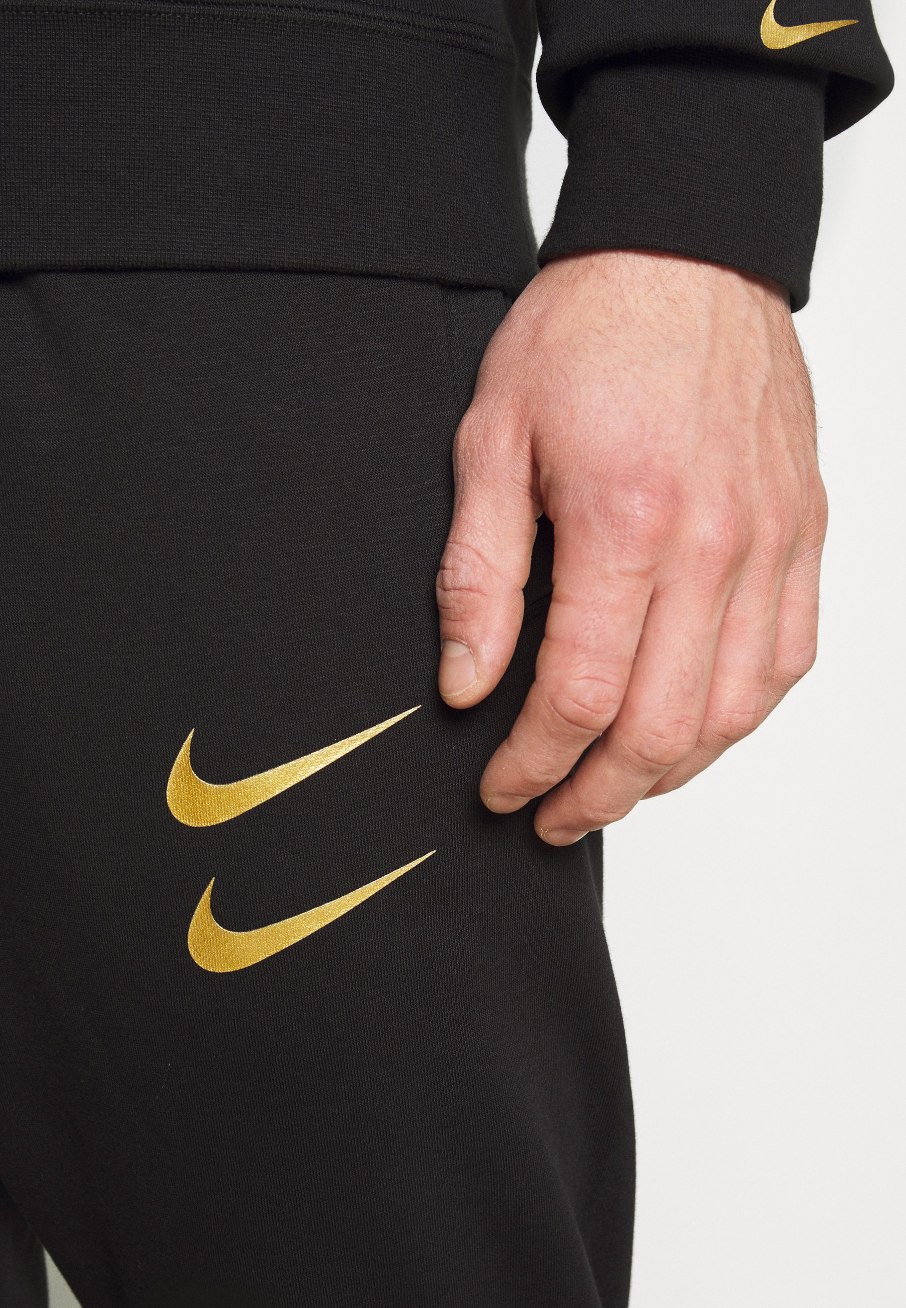 nike black and gold tracksuit