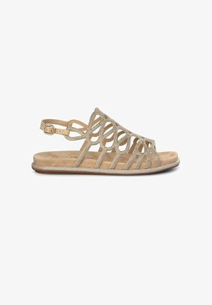 Beige sandaal met een ingewikkeld uitgesneden ontwerp, versierd met glinsterende accenten. Beschikt over een verstelbare enkelriem en een platte zool.