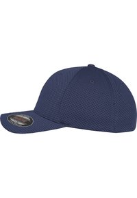 Navy blue cap made of textured mesh material. Features a curved brim and a fitted design. Includes a circular size tag on the side.