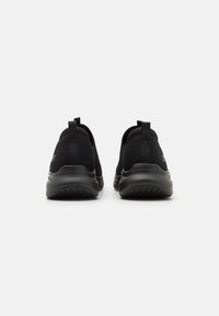 Black athletic shoes featuring a mesh upper, cushioned sole, and pull tabs at the heel for easy wear. Durable rubber tread for traction.
