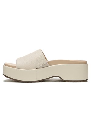 Beige platform slide sandals with a textured leather upper, wide strap, and a thick rubber sole featuring a zigzag tread pattern.