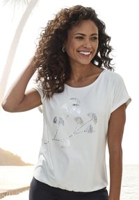 Witte t-shirt met korte mouwen en een zilveren bloemmotief. Zacht materiaal met een relaxed fit en een geraffineerde zoom.