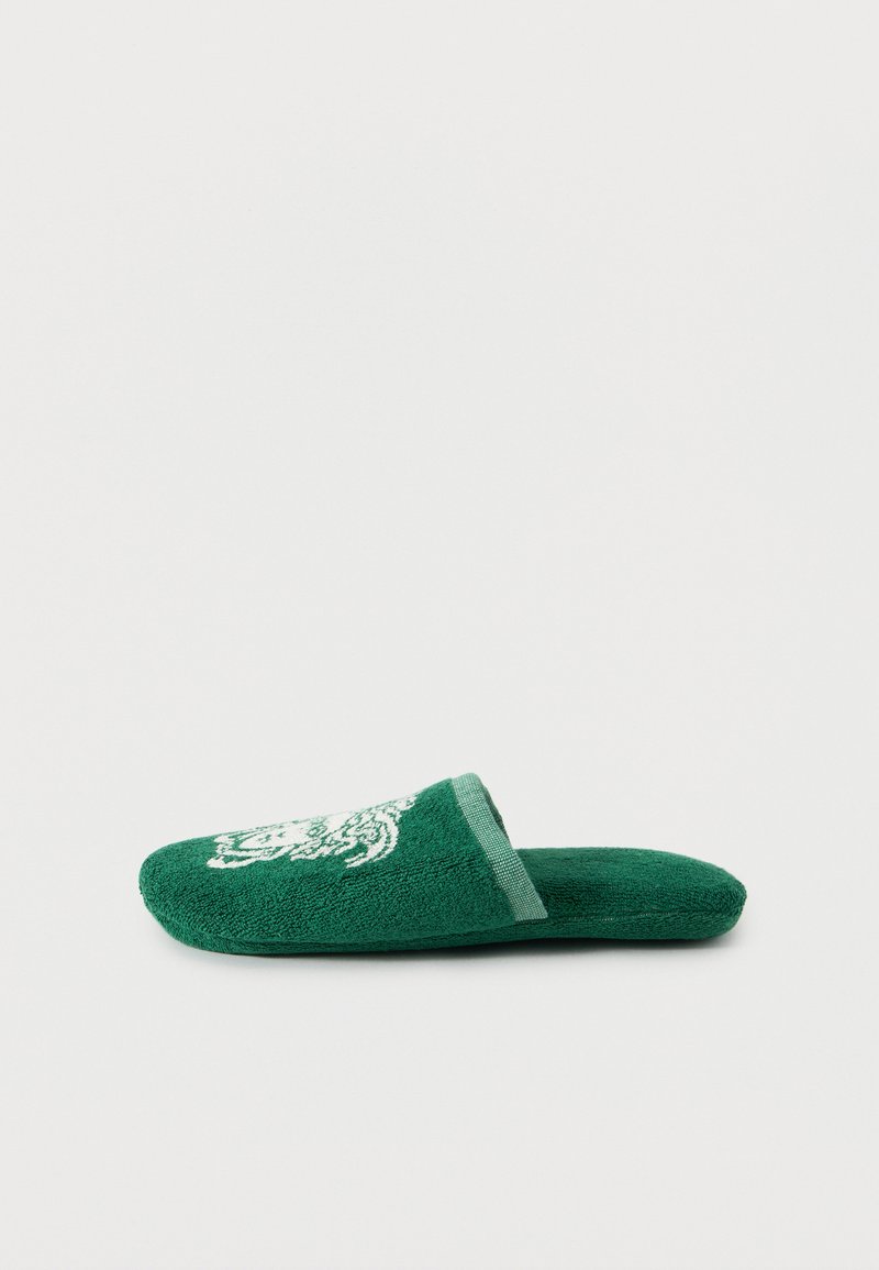 Πράσινο παντόφλα από περκάλι με ανοιχτή πλάτη και λευκό κεντημένο κεφάλι τίγρης στην κορυφή, εμφανίζεται από το πλάι σε απλό φόντο.