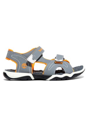 Gray sporty sandals with orange accents, adjustable Velcro straps, textured black sole, and white trim detail. Lightweight design for comfort.