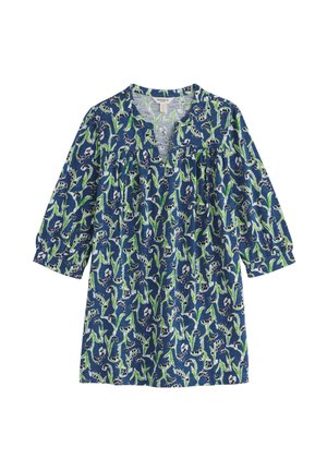 Haut tunique bleu avec un motif floral vert et blanc, manches trois-quarts et encolure fendue.