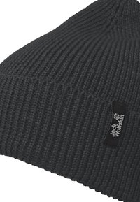Black knit beanie with a textured rib pattern. Features a small black label with white logo on the side. Durable material for warmth.