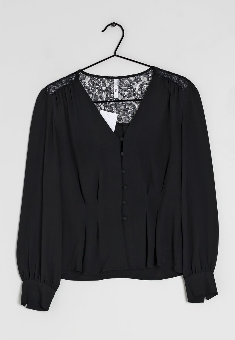 Black blouse with long sleeves, V-neck, lace accents on shoulders, button front closure, pleated detail, and button cuffs. Lightweight fabric.