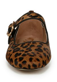 Chaussure plate imprimée léopard avec un bout rond, fabriquée en fausse fourrure marron texturée, dotée d'une sangle noire et d'un accent de boucle dorée.