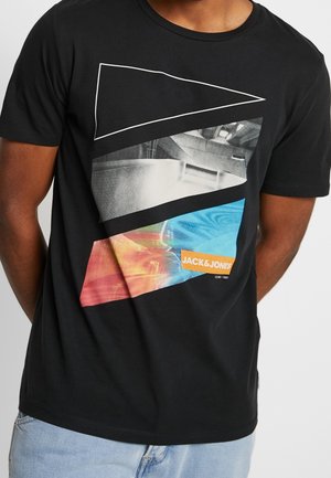 Black cotton T-shirt featuring a geometric graphic design in blue, red, and gray. "JACK & JONES" logo in orange at the bottom.