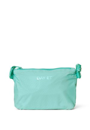 Mint green nylon bag with a zip closure, rope handle, and reflective "DAY ET" logo. Smooth texture, compact rectangular shape, and minimal design.