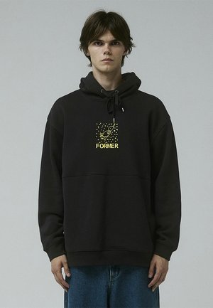 Black hooded sweatshirt made of soft material, featuring a central graphic in yellow with the word "FORMER" and a rocket design.