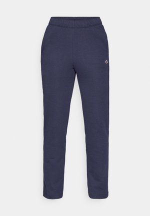 Un pantalon de survêtement bleu marine en tissu doux, doté d'une ceinture élastique et d'un petit patch logo sur la cuisse. Conception à jambes droites sans poches.
