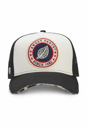 Casquette camionneur blanche et noire avec un écusson circulaire portant l'inscription "Sweet Pants Since 1982" et un motif de feuille au centre.