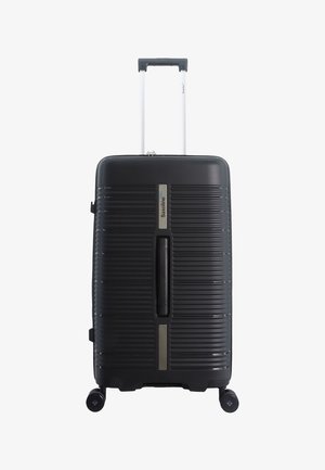 Black hard-shell suitcase with horizontal ridges, telescoping handle, and four wheels. Features a metallic logo and textured accents.