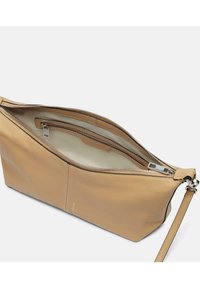 Pochette en cuir texturé beige avec une fermeture zippée, des poches intérieures et une forme flexible. Elle dispose d'une sangle amovible pour plus de polyvalence.
