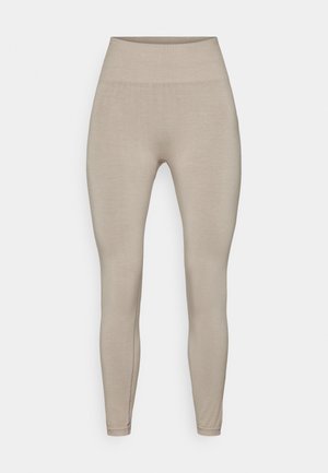 Beige leggings med høj talje, lavet af glat, strækbart materiale. De har et tætsiddende, tapered design og ingen synlige mønstre eller hardware.