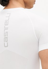 White athletic shirt featuring a textured design, short sleeves, and Castelli branding in subtle gray on the back.