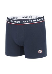 Boxers pour hommes bleu marine avec une ceinture élastique arborant le texte "SERGE BLANCO" et un accent rouge. Comprend un patch logo circulaire sur la jambe.