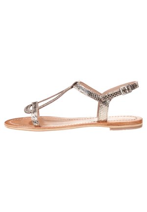 Sandalo piatto in metallo argentato, con motivo in pelle di serpente, design a T-strap, fibbia regolabile alla caviglia e soletta in pelle naturale.