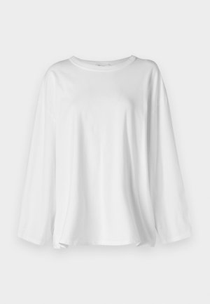 Camicia bianca a maniche lunghe realizzata in cotone morbido, con scollatura rotonda, vestibilità ampia e spacchi laterali per facilitare i movimenti.