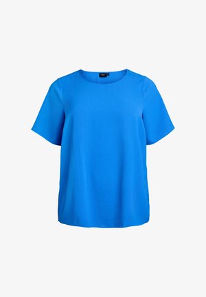 Niebieska bluzka z krótkim rękawem, z okrągłym dekoltem, gładką fakturą i luźnym, oversize'owym krojem. Brak widocznych wzorów i detali metalowych.