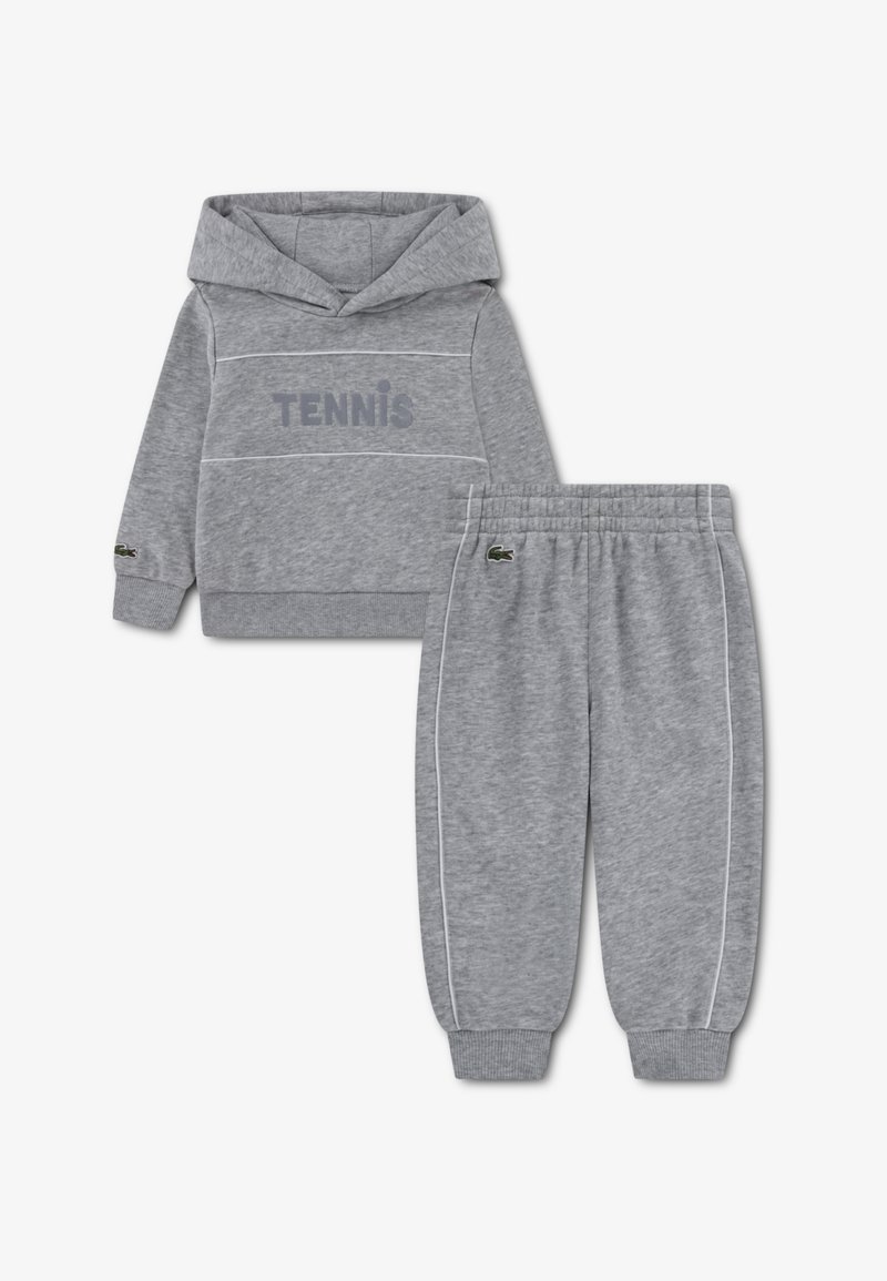 Ensemble sweat à capuche et pantalon de survêtement gris, comprenant une capuche, l'inscription "TENNIS", des accents blancs et des poignets élastiques. Tissu doux avec détail du logo.