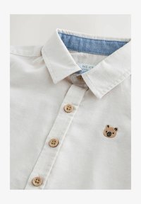 Ausgewählt, ecru character