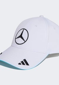 White baseball cap with a black Mercedes logo and black Adidas three stripes accents. Features a turquoise underbrim and fabric texture.
