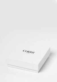 Weißer rechteckiger Geschenkkarton mit glatter Oberfläche, der den Markennamen "CHRIST" in fetter schwarzer Schrift auf der Oberseite trägt.