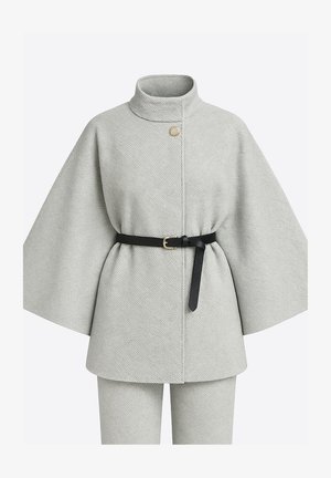 Grå vævet kappe med høj krave, enkelt guldknap og sort bælte. Har vide ærmer og en struktureret overflade.